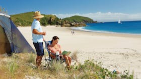 COuple in front of tent near beach in Keppel Islands
