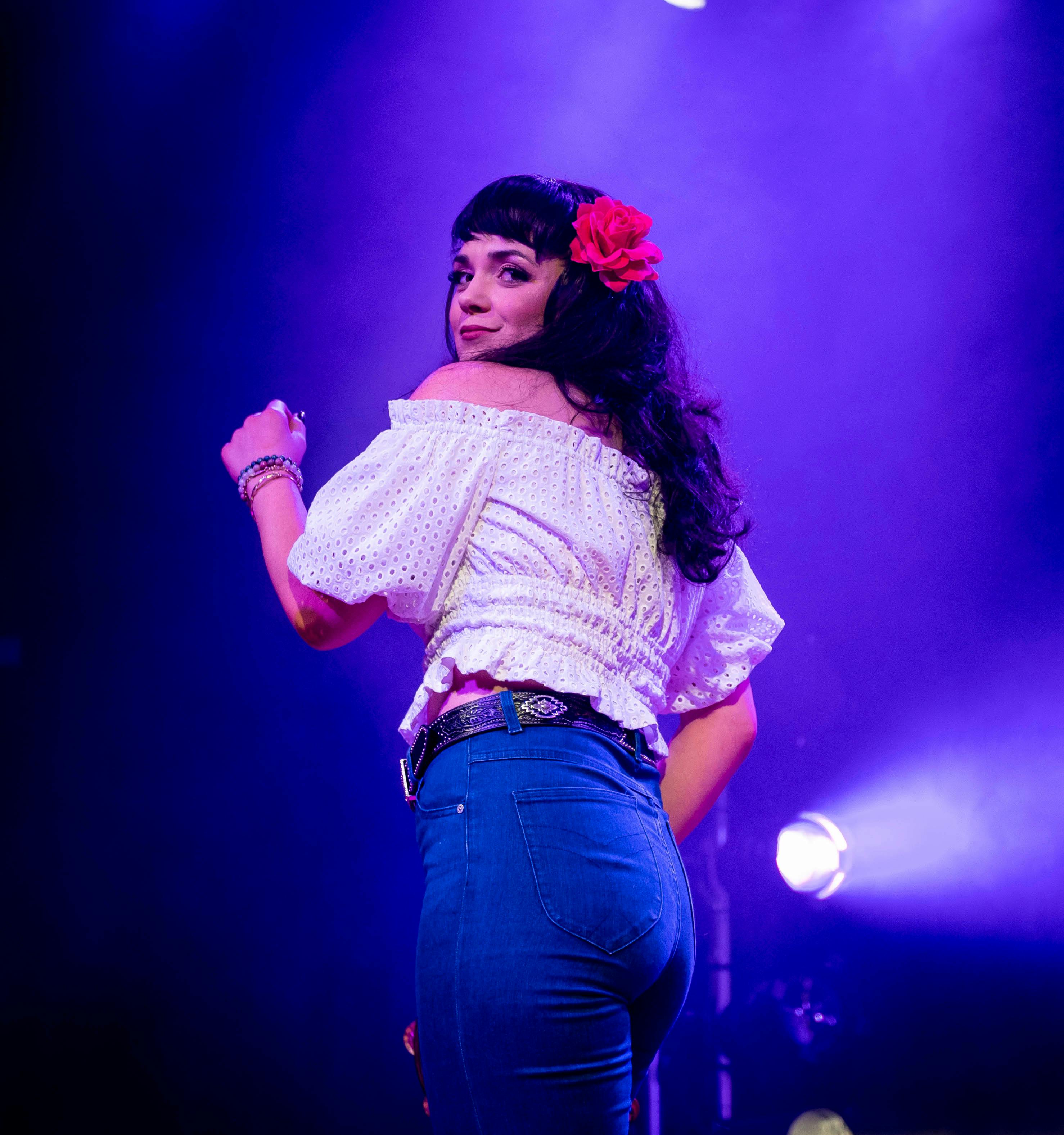Beautiful singer with flower in her long brown  hair looks like Linda Rhonstadt