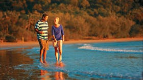 Couple walking on the beach in Cape Hillsborough