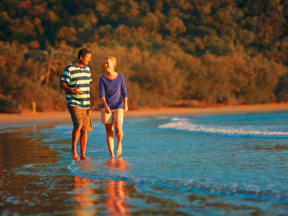Couple walking on the beach in Cape Hillsborough Couple walking on the beach in Cape Hillsborough