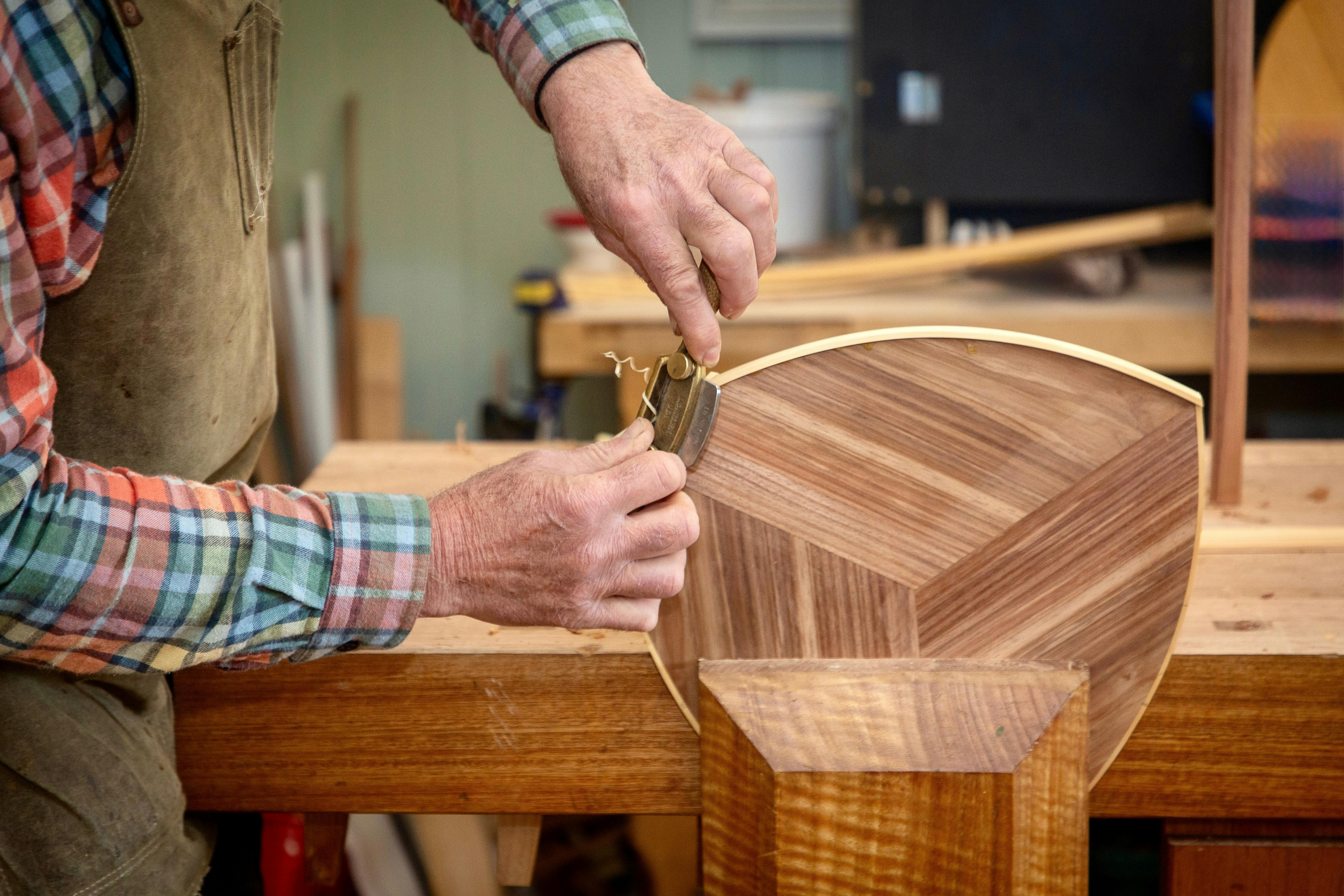 A furniture maker works on a Blackwood table top