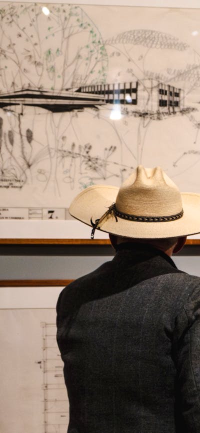 Man looking at architectural sketches in the Taglietti exhibition