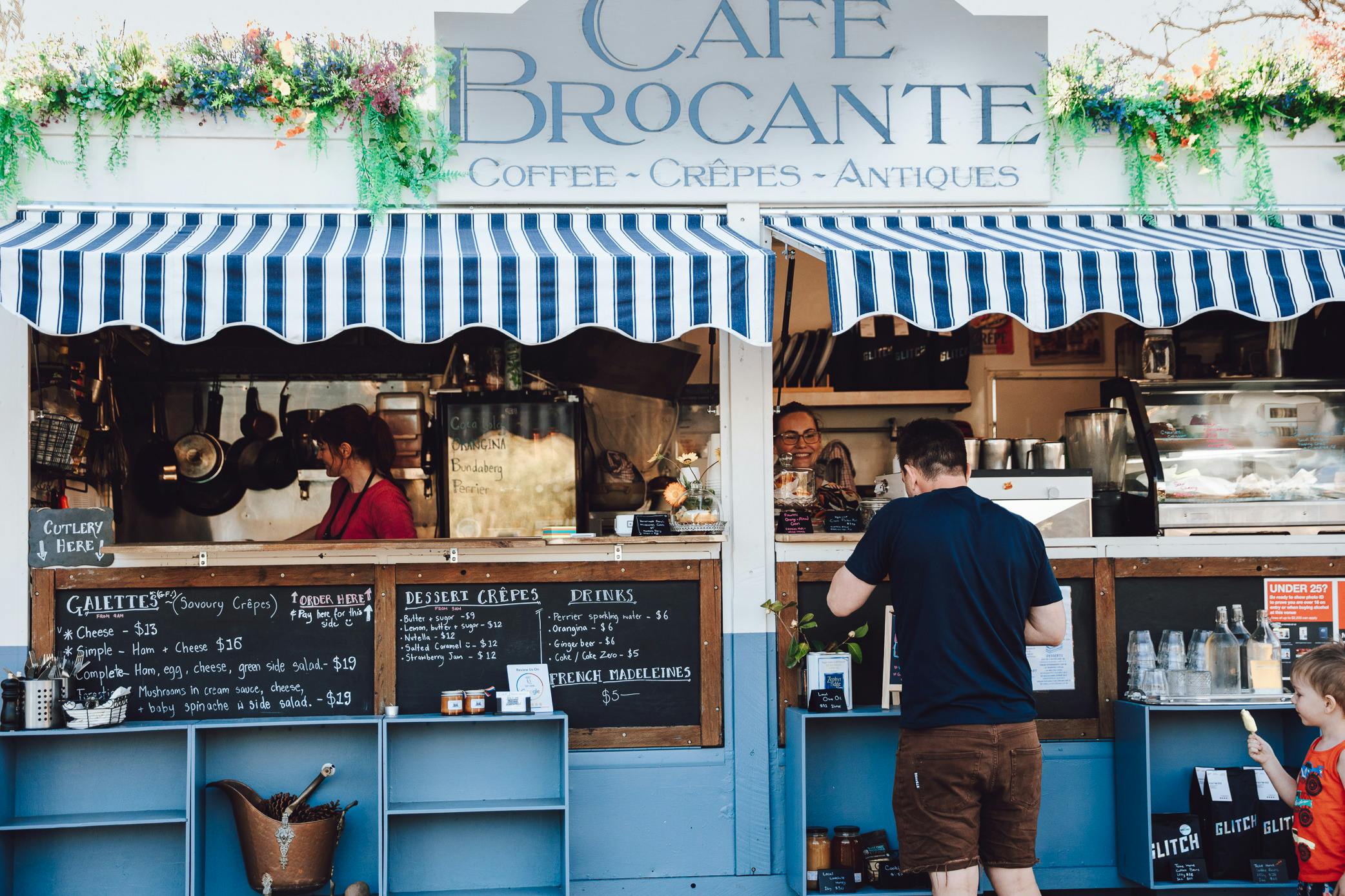 Man looking at menu of Cafe Brocante Food Truck Cafe