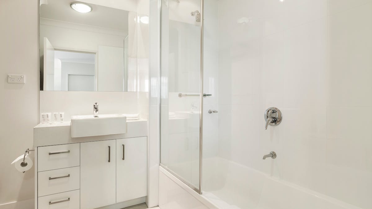 Shower over bath, washer, dryer, basin, toilet