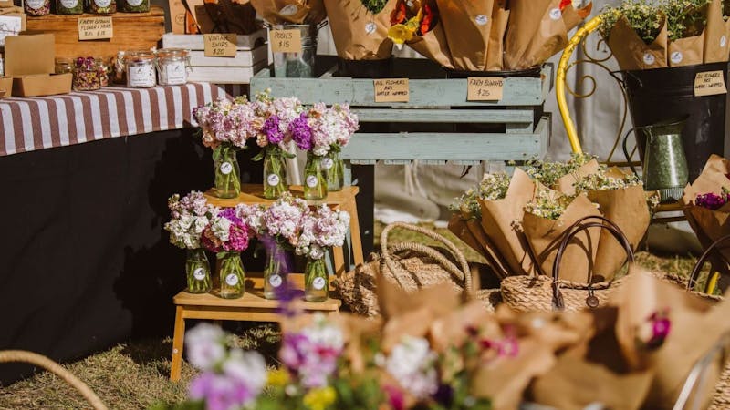 Stall with a range of beautiful, colourful flower bouquets and vases at Winter Harvest Festival