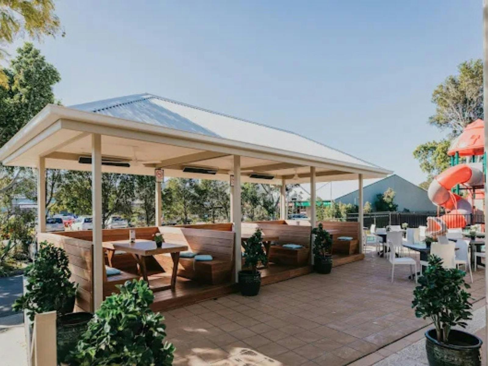 outdoor cabana dining area with a kids playground off to the side