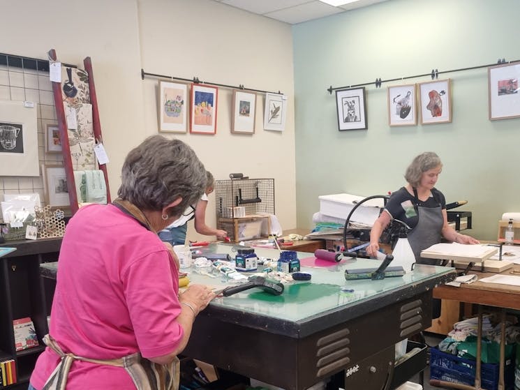 artists using the studio space to print linocuts