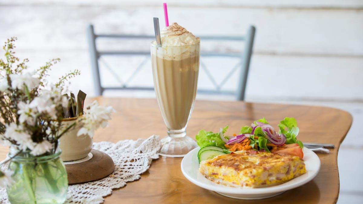 Delicious home-made quiche and garden salad, accompanied by ice cold iced coffee.