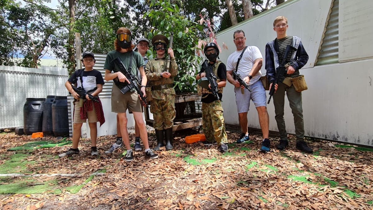 People holding gel blasters and wearing head protection