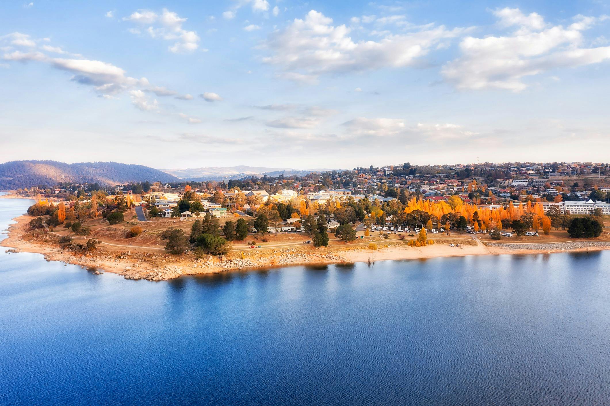 Township and lake of Jindabyne. View of the town, lake, blue sky and clouds.