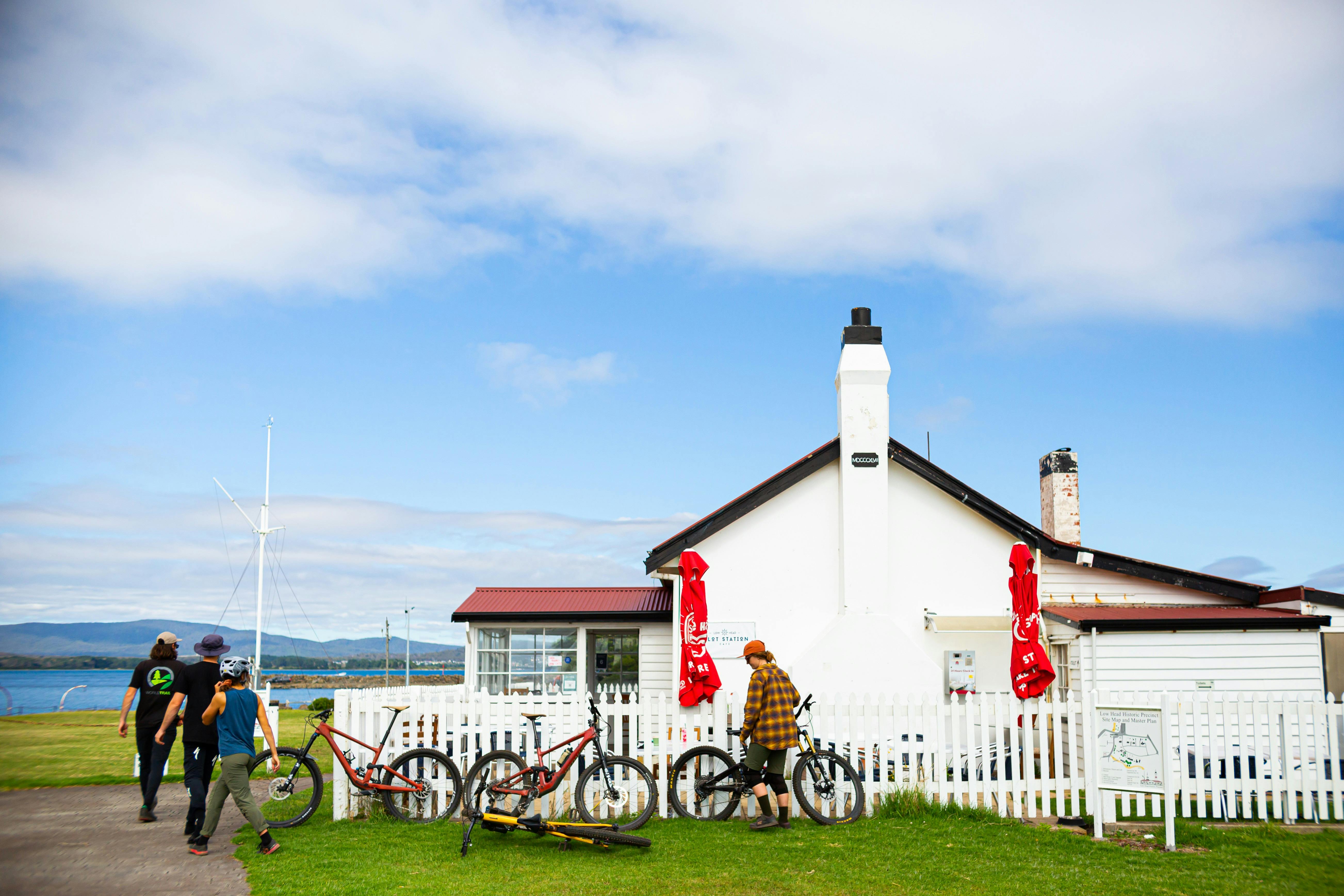 Historic building with people and mountain bikes gathered outside