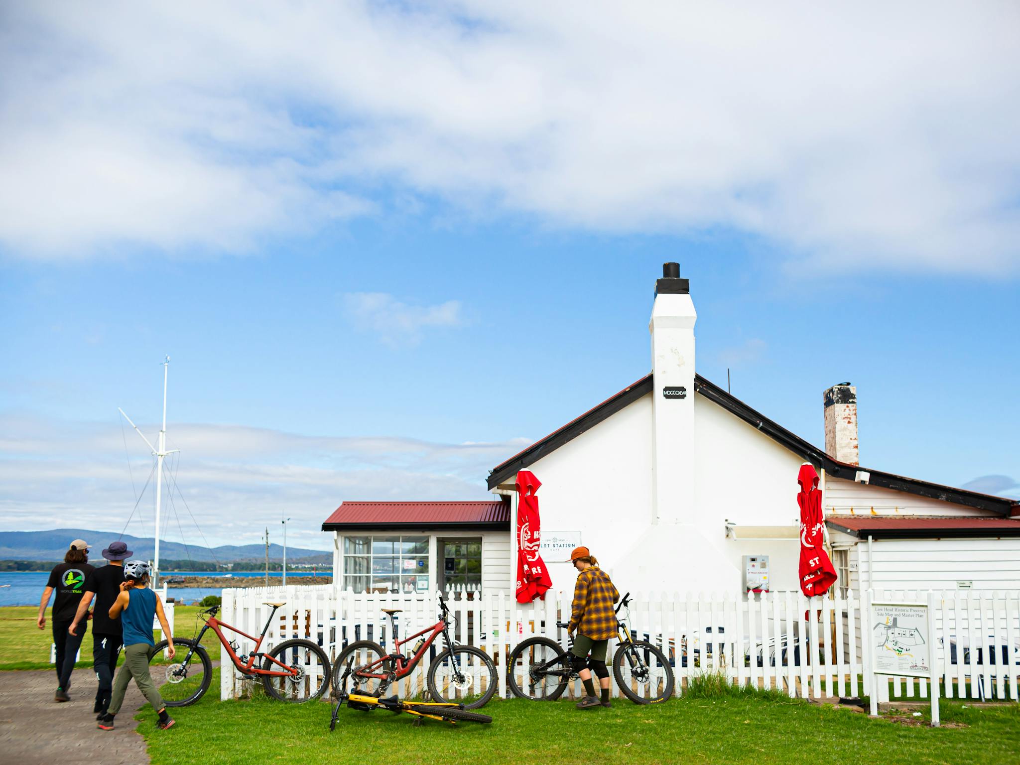 Historic building with people and mountain bikes gathered outside