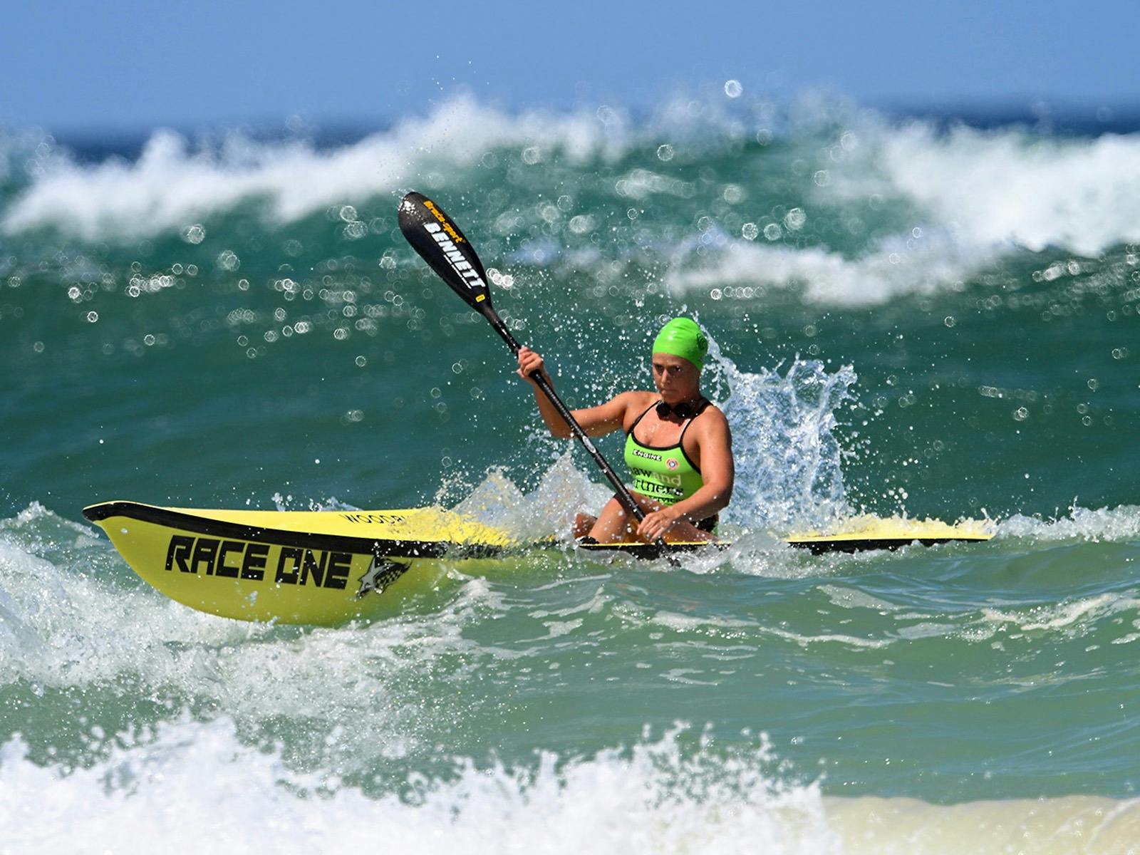Series mainstay Lizzie Welborn navigating large swell on a surf ski