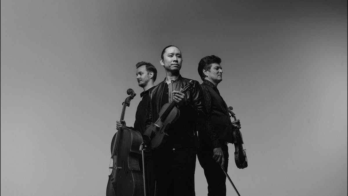 Rory Smith holding Cello, Jason Tong holding Violin and Brendan Joyce holding Violin