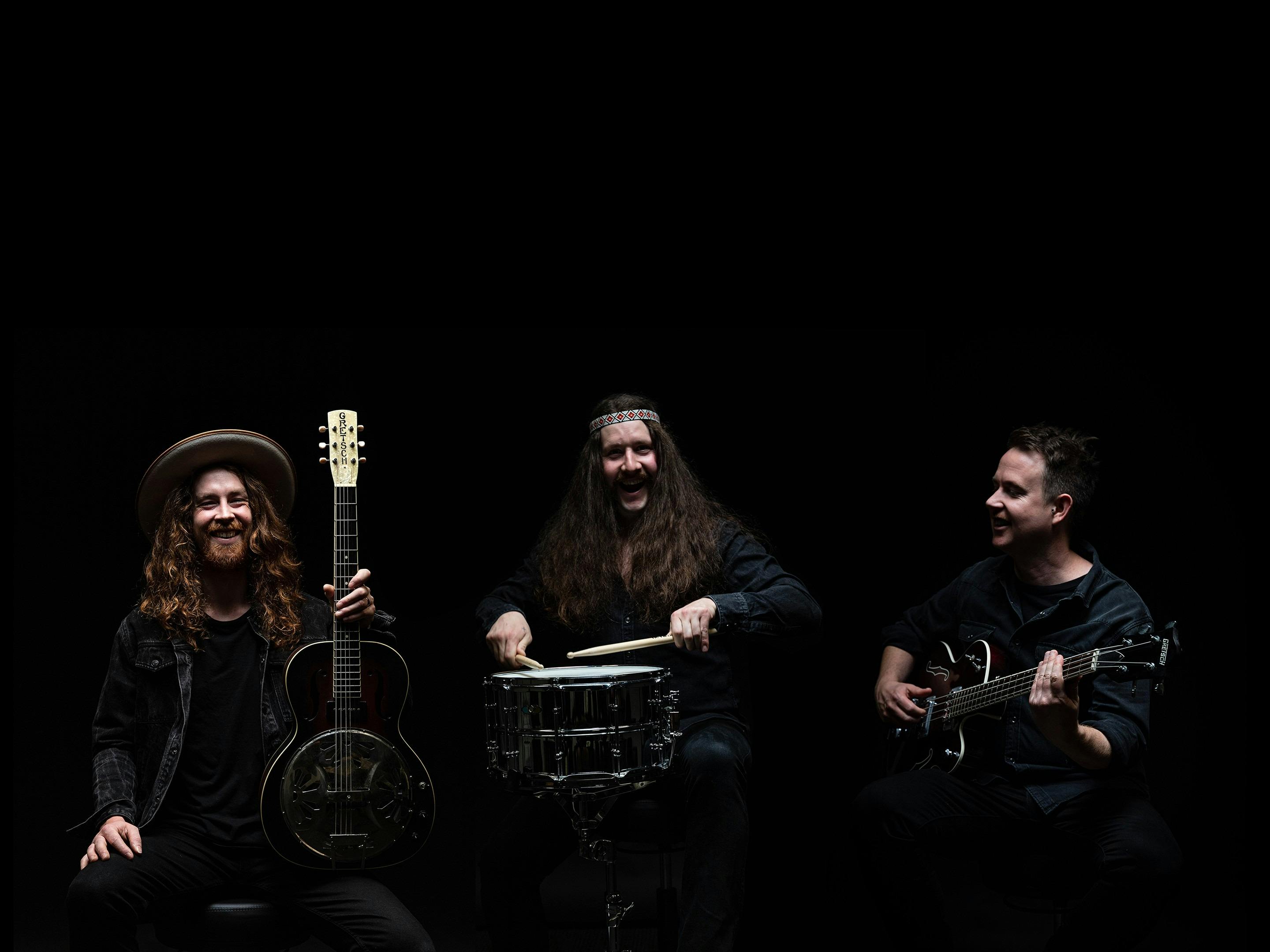 Band members of Smoke Stack Laughing with their instruments