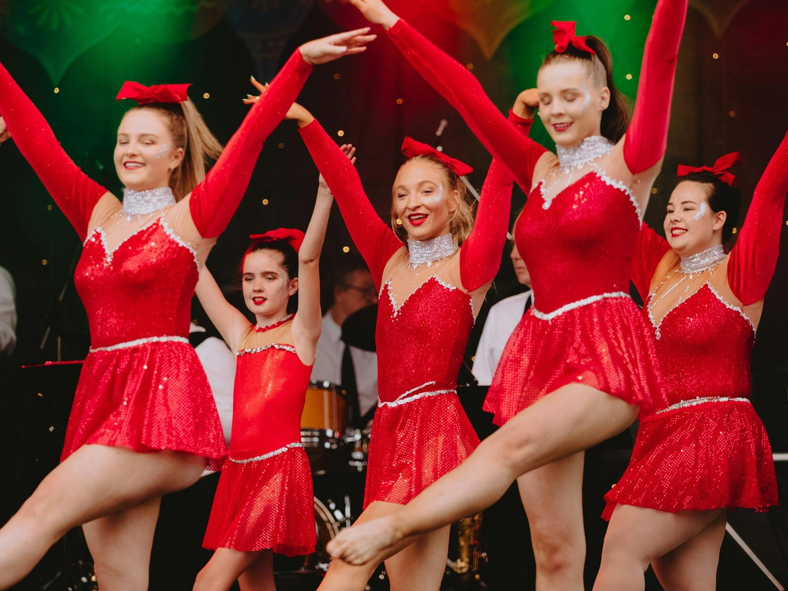 Dance group performing on stage.