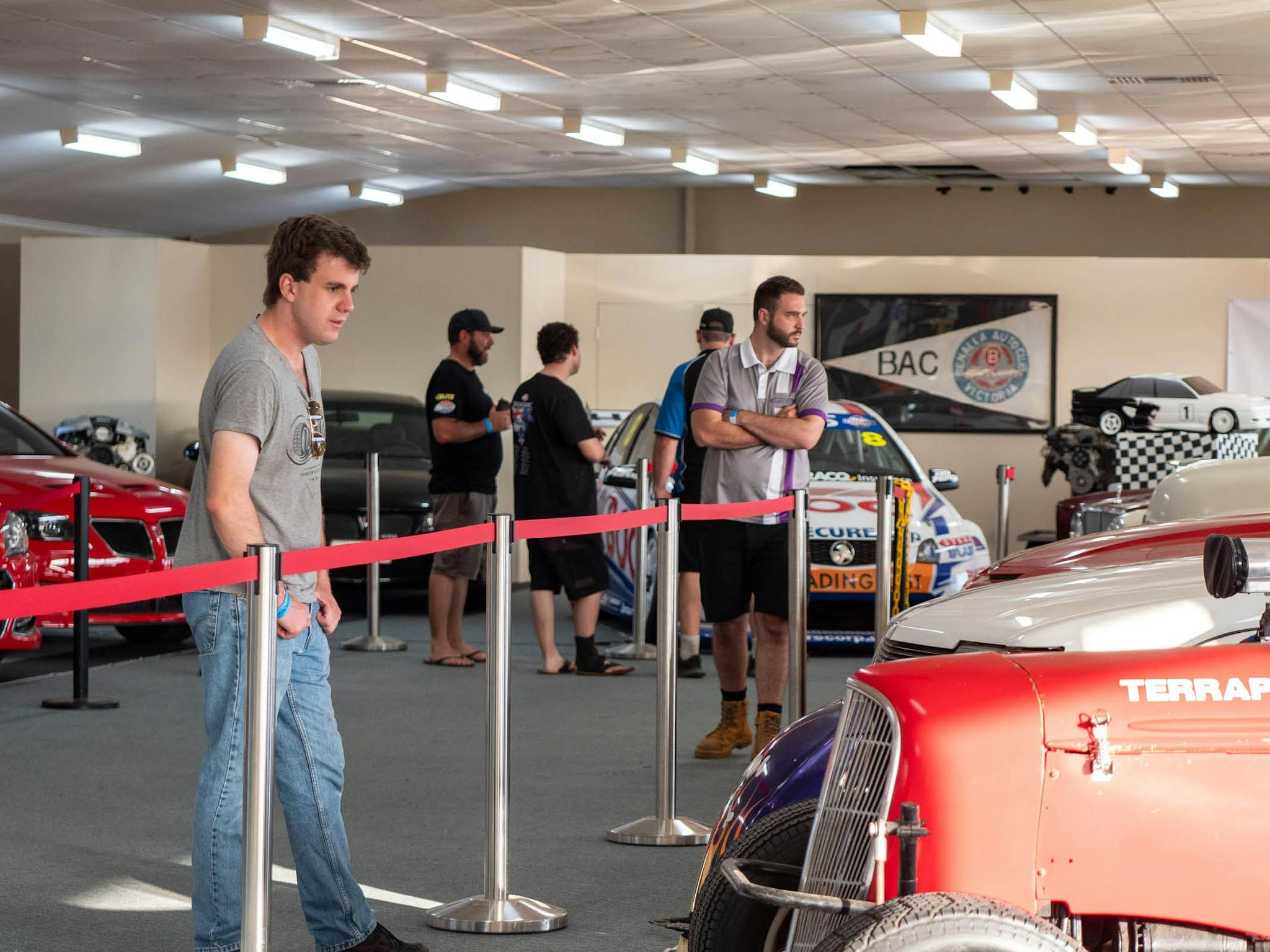 Visitors looking at racing and classic cars