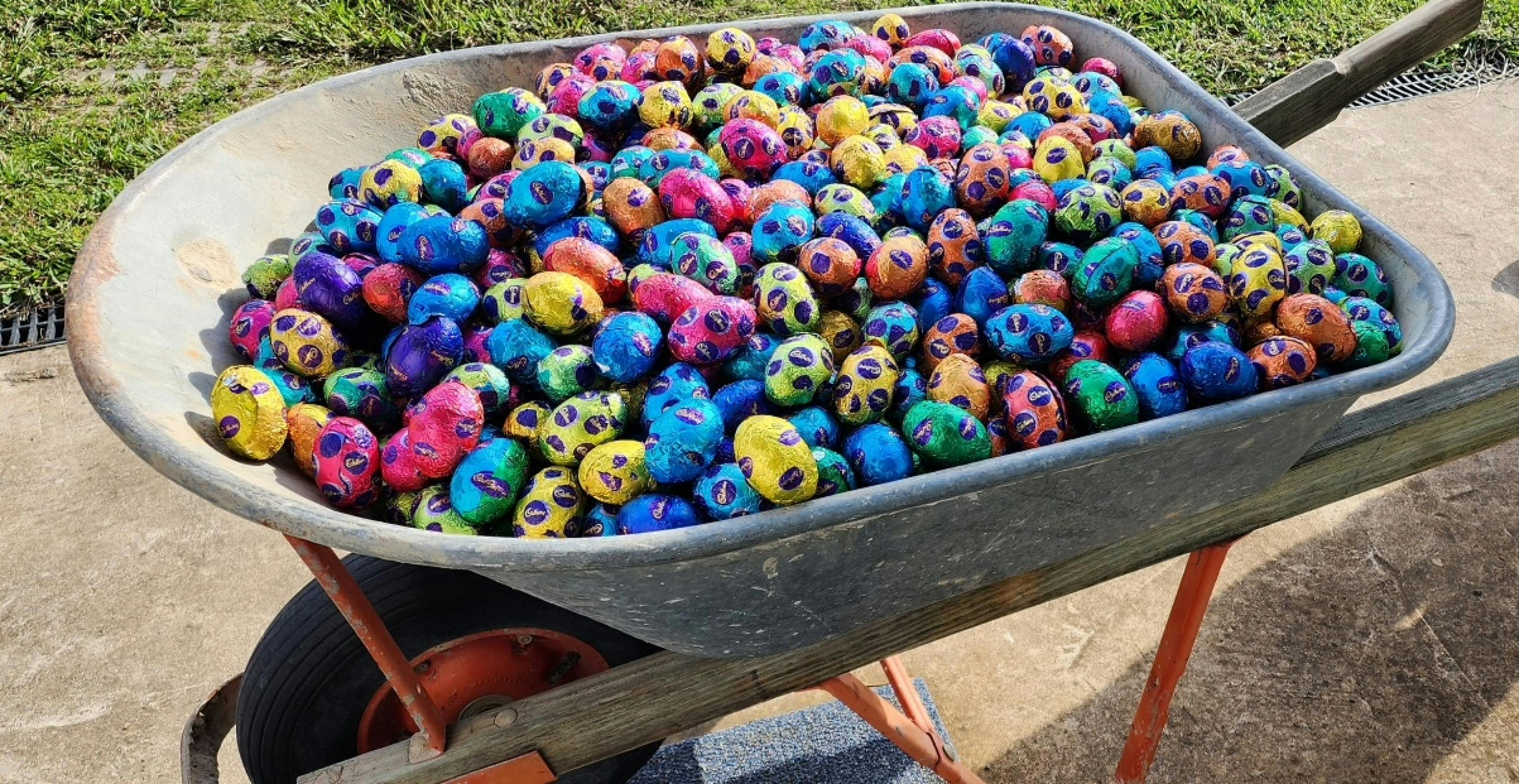 A picture of a wheelbarrow full of Easter Eggs