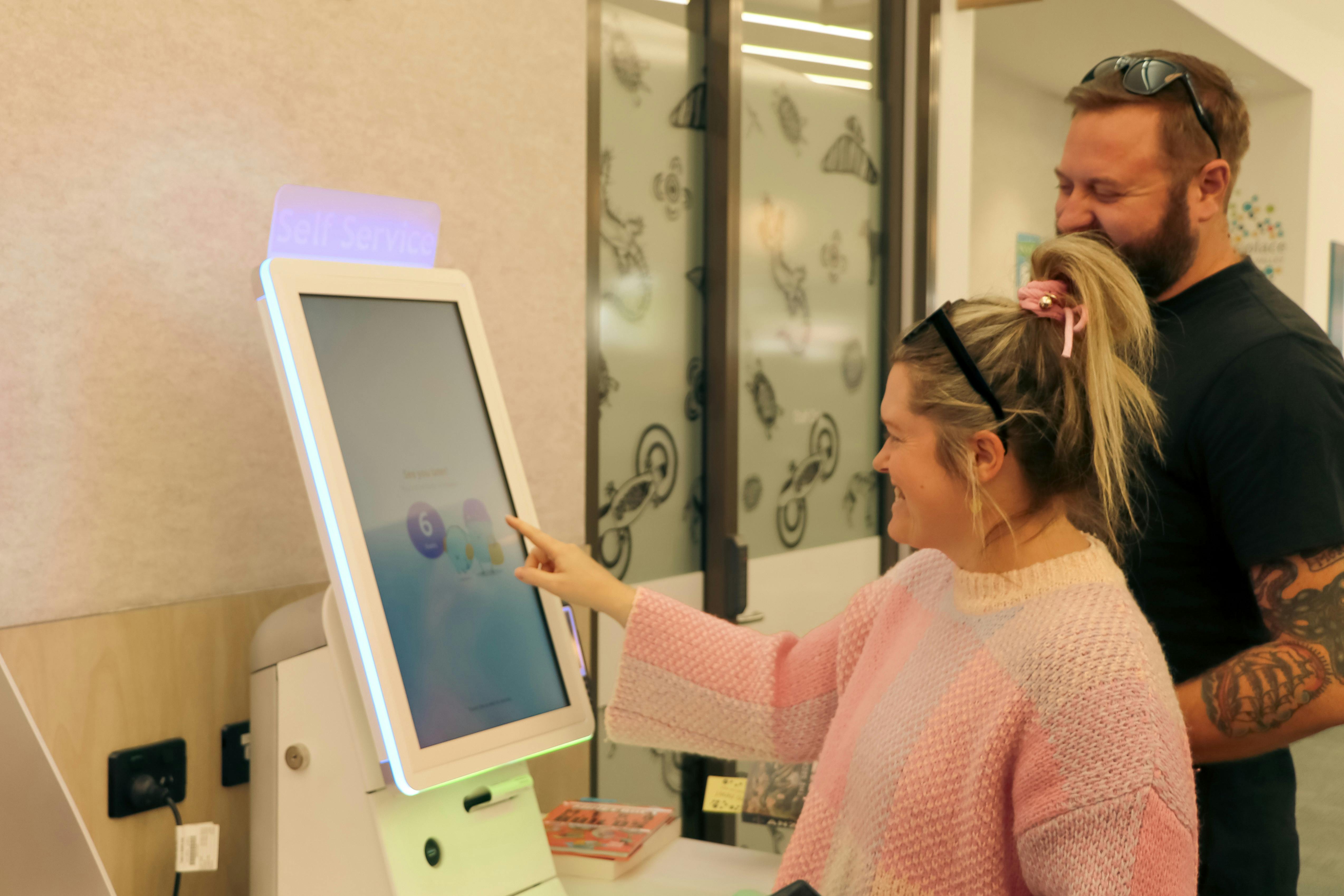 A person using the self check out staition.