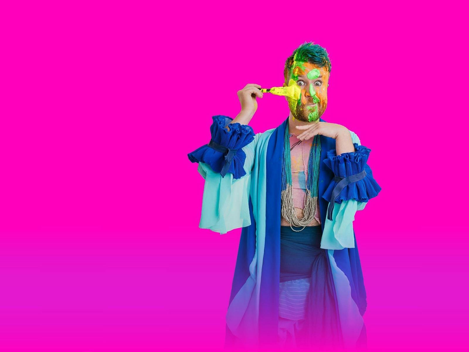 Bearded man painting his face yellow