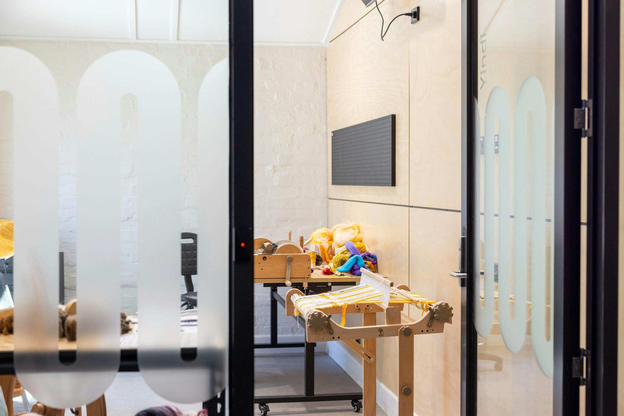 woven work on a loom, yellow and white yan