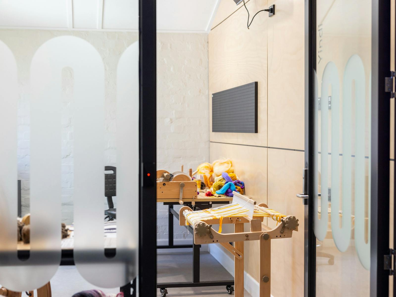 woven work on a loom, yellow and white yan