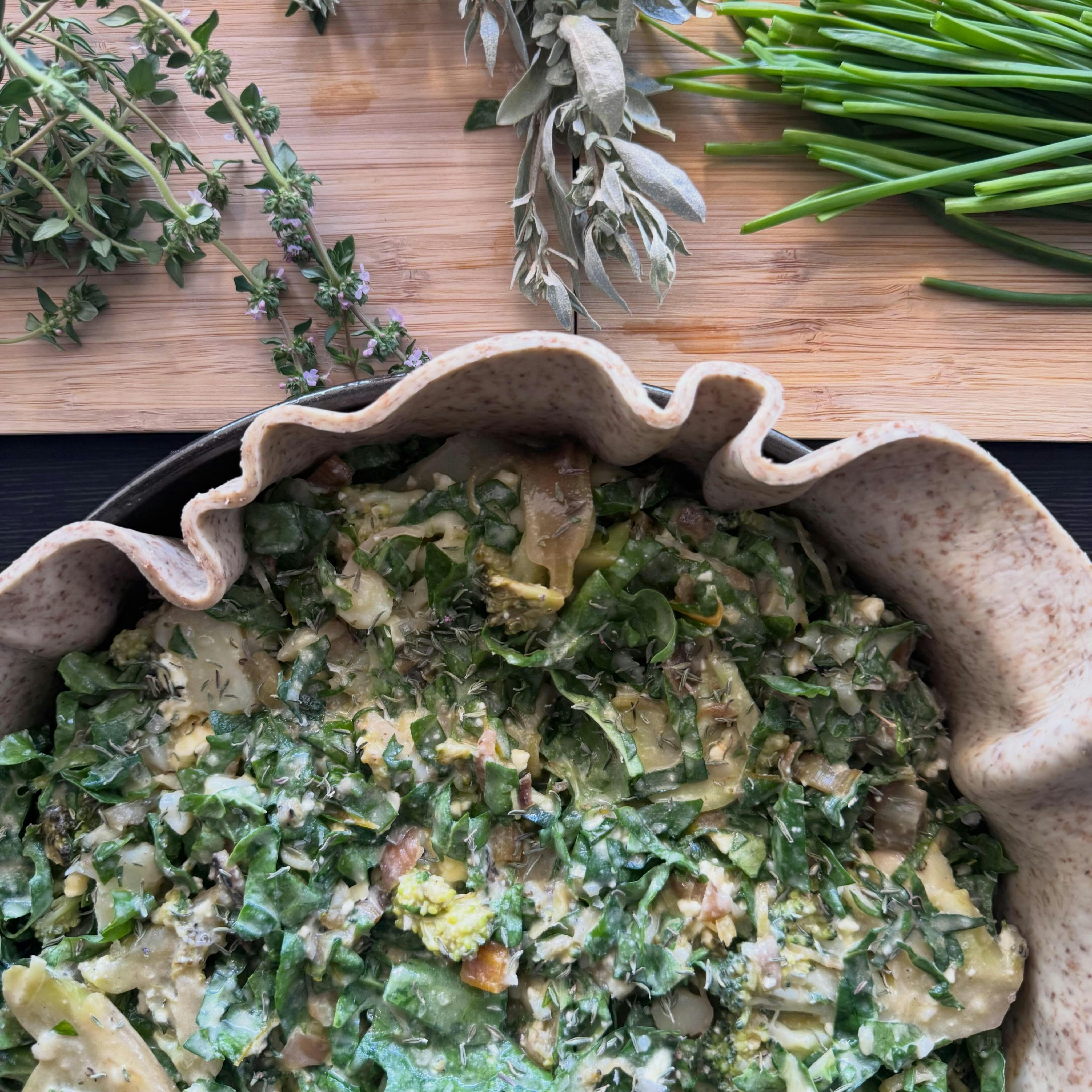 Rustic pastry shell filled with spinach ready to be cooked
