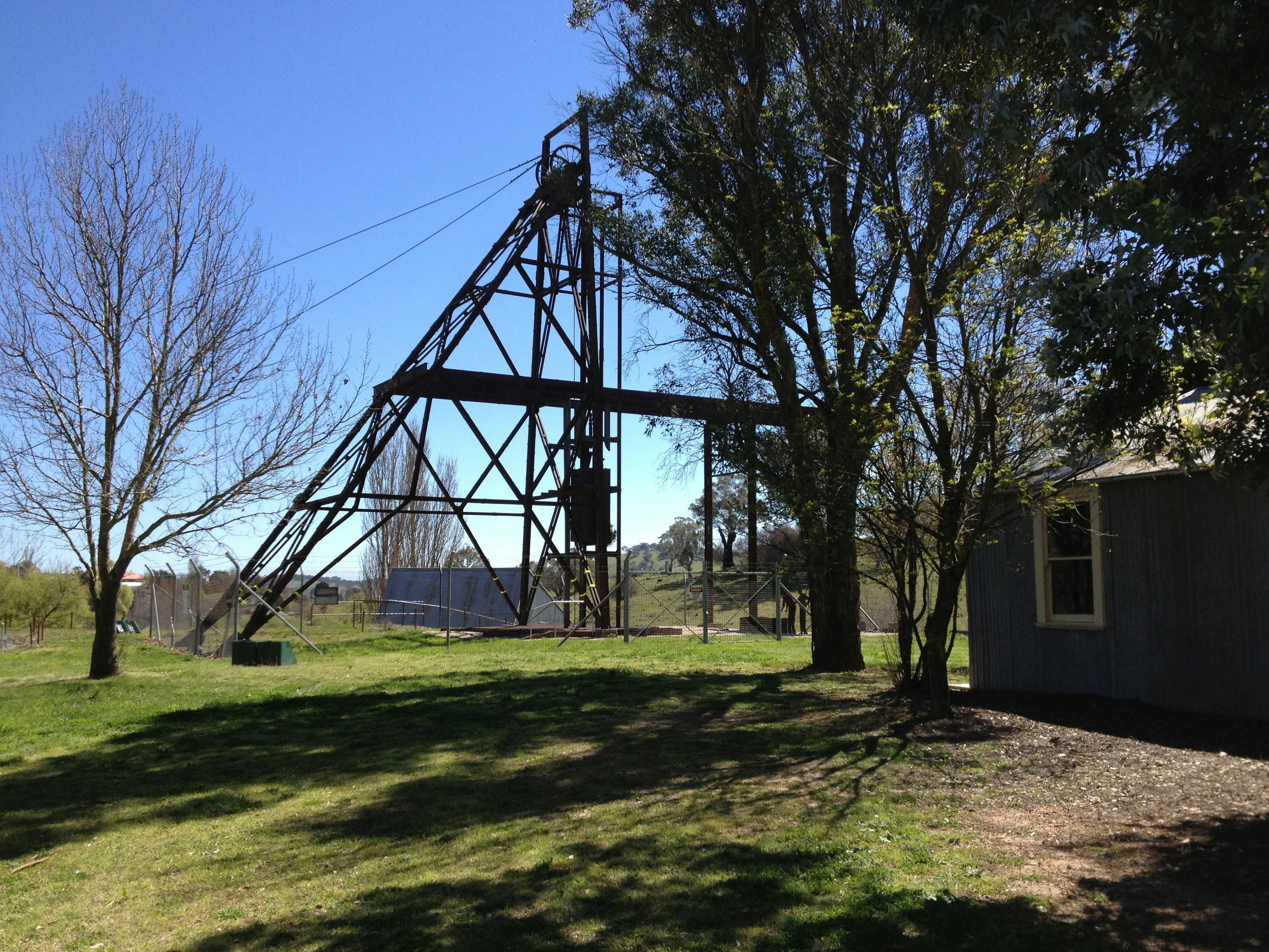 Wentworth Mine Poppet Head on site with trees and shed in foreground