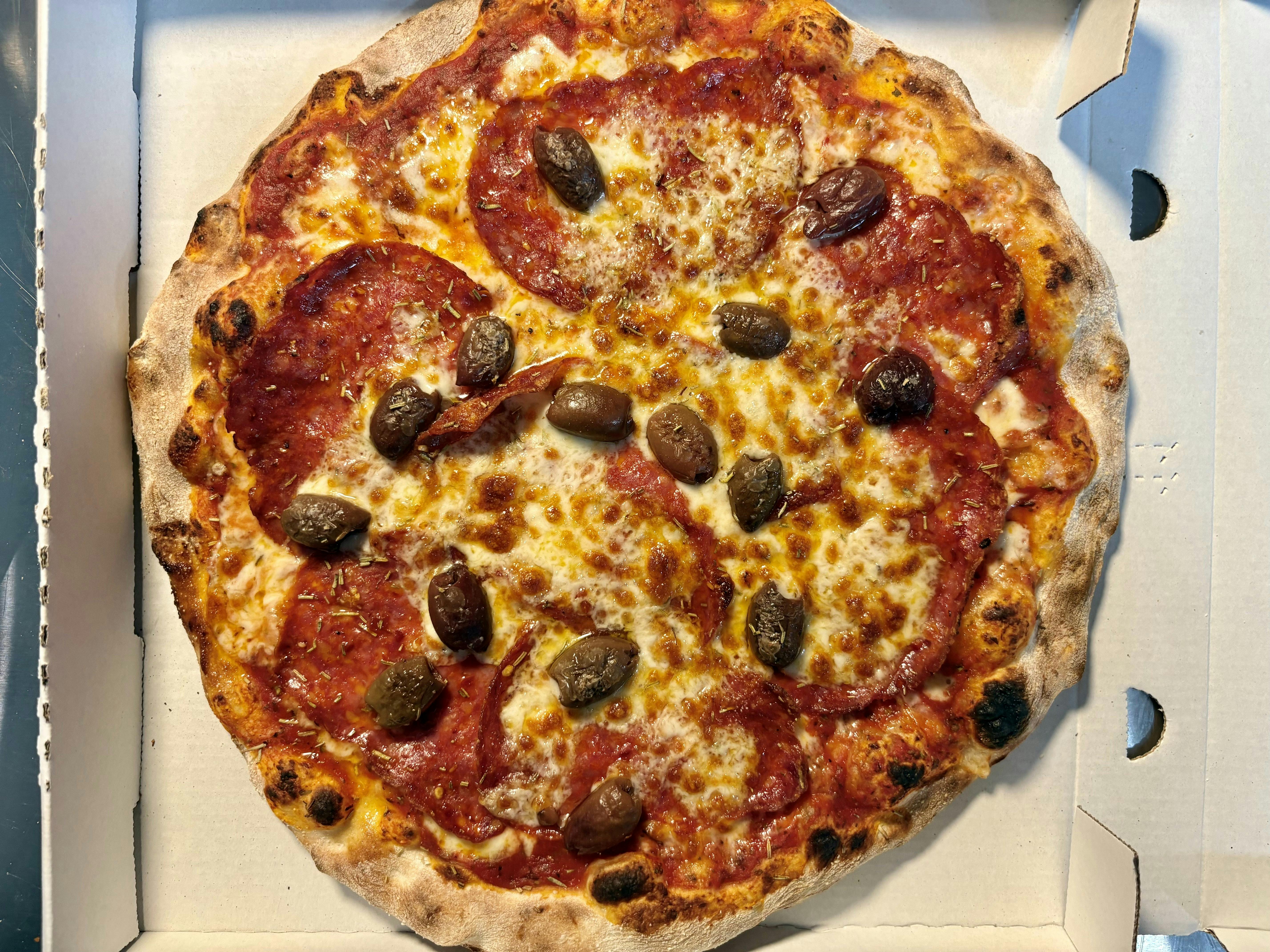 Spicy Diavola pizza with spicy salami and olives