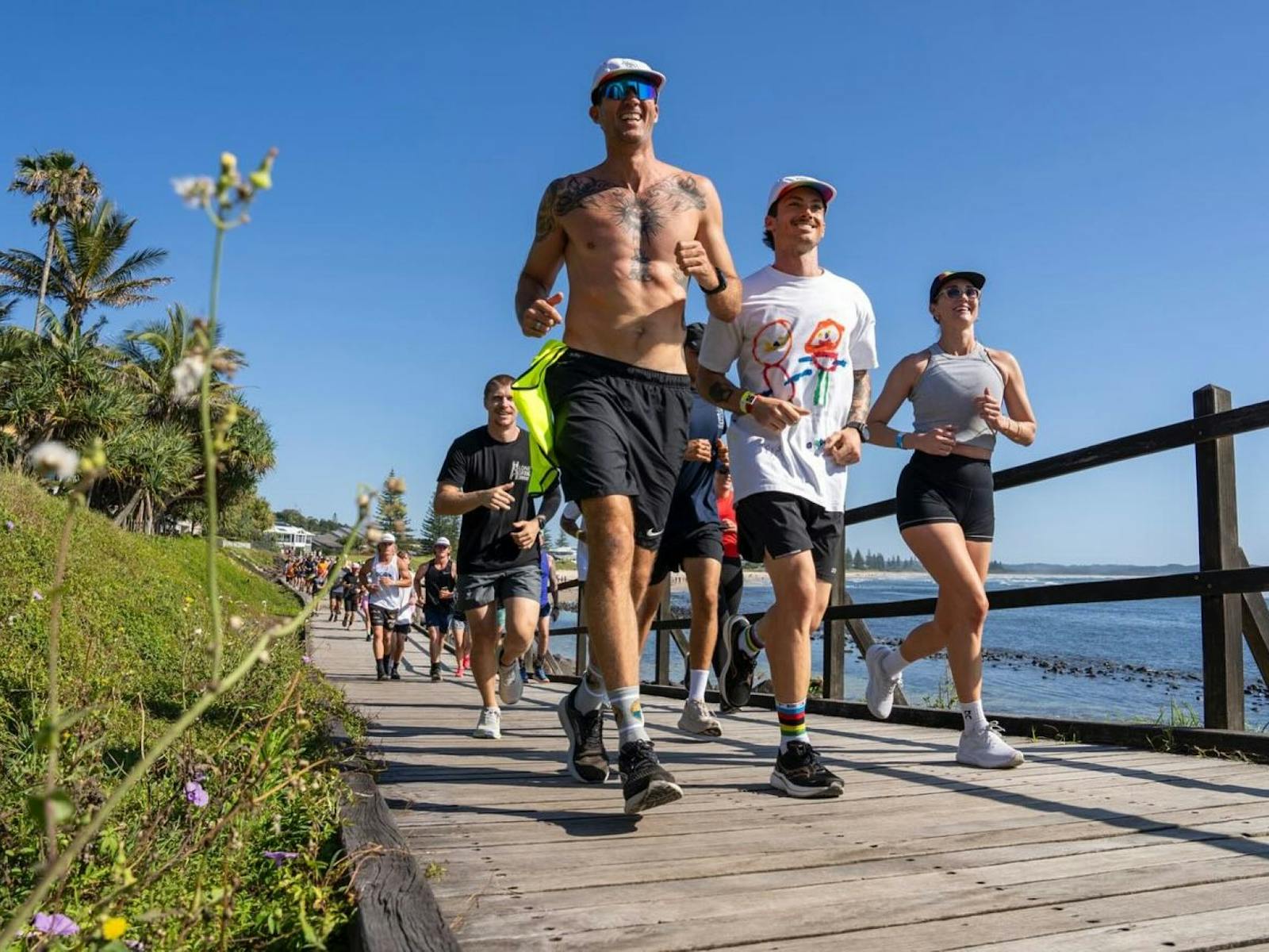 Crowd of people running along the Lennox boardwalk