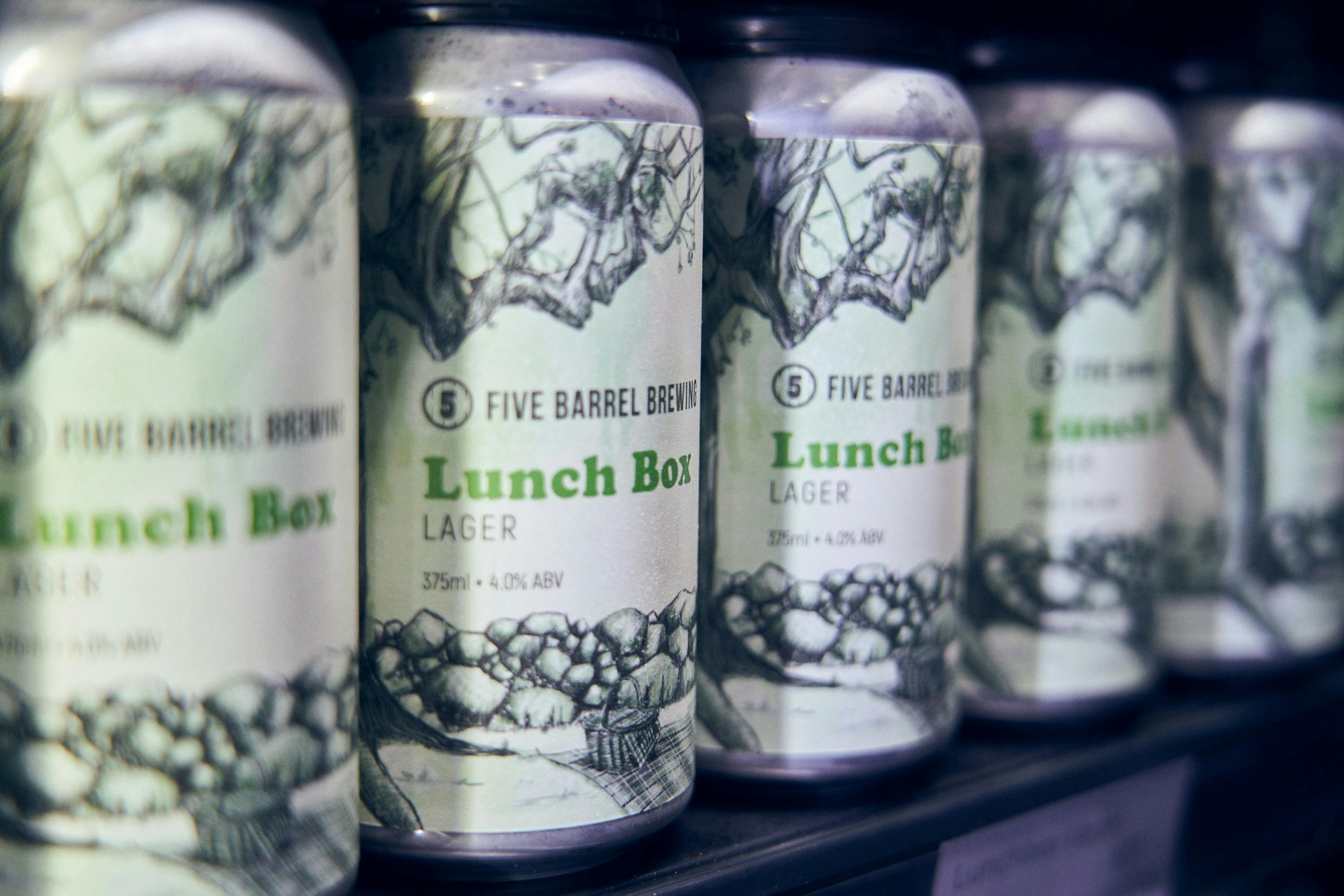 Row of cans of Lunchbox Lager ready to take home to enjoy