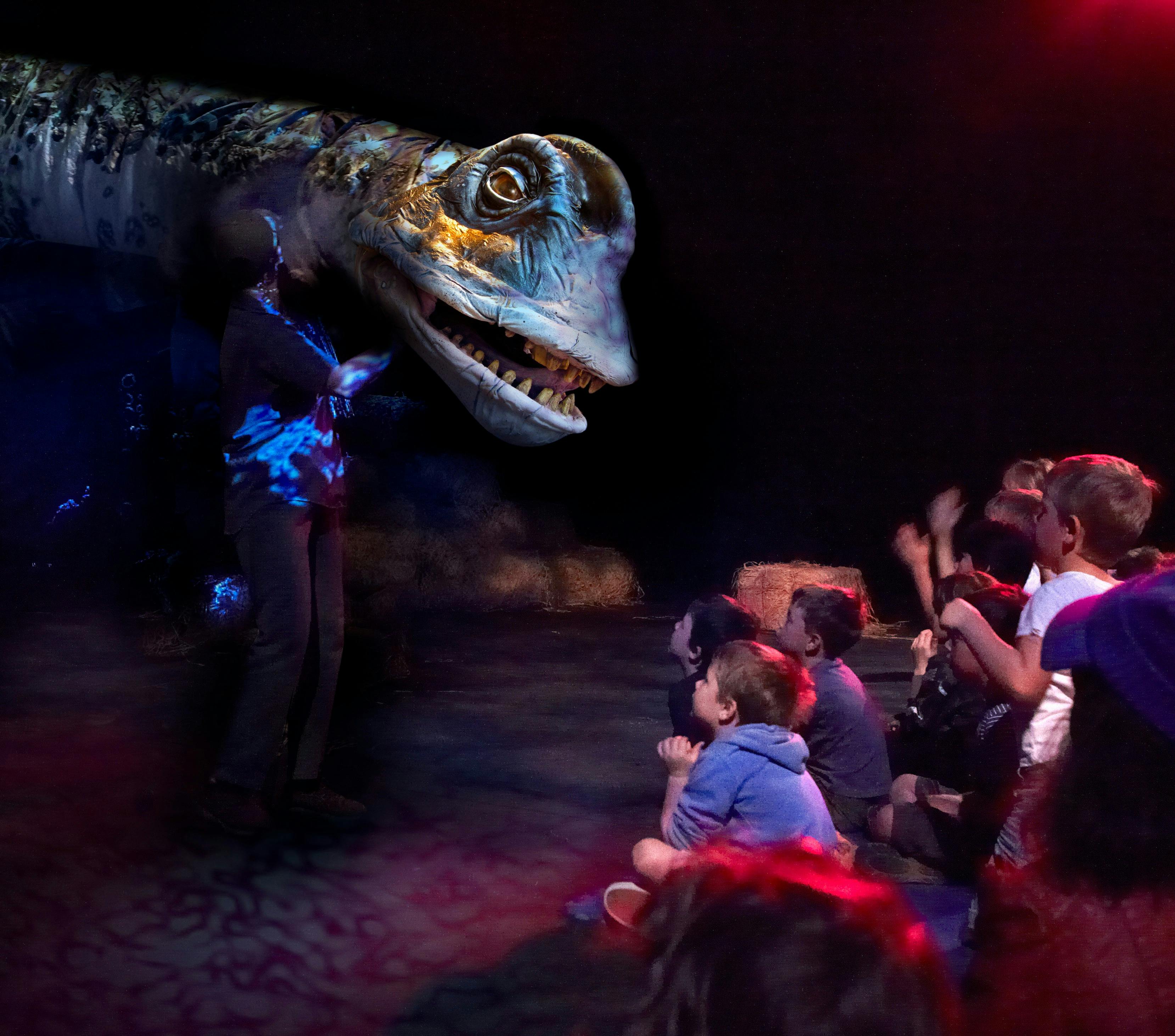 Dinosaur puppet infront of group of children