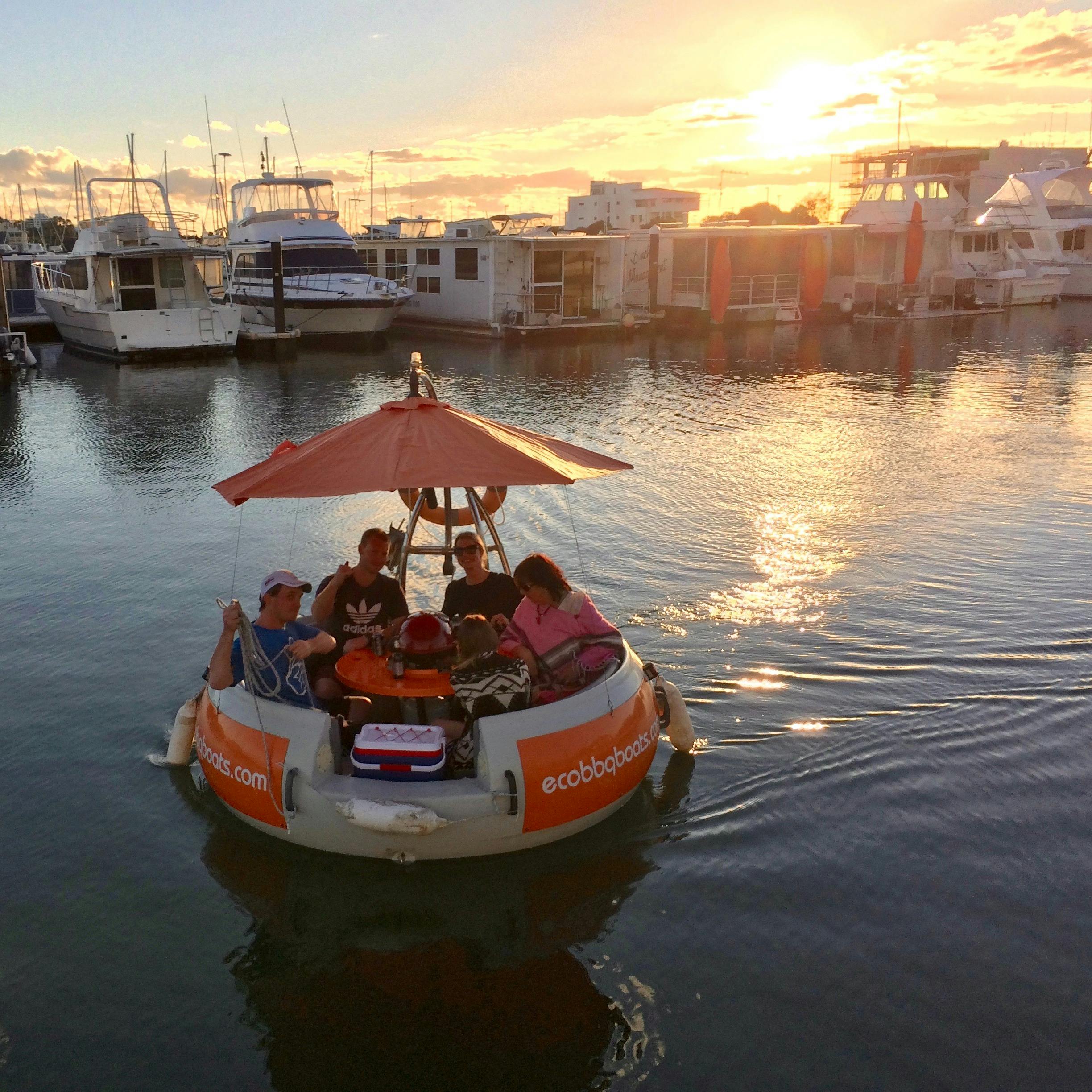 BBQ Boat sailing at sunset