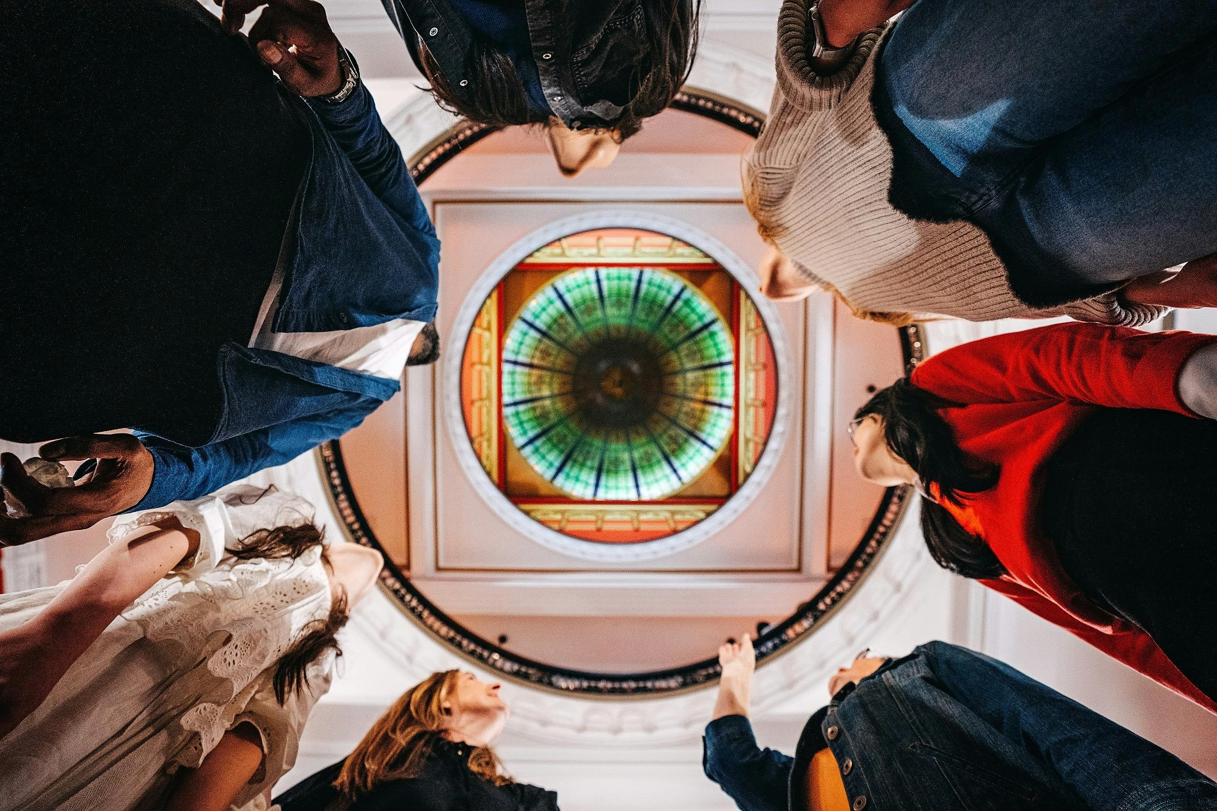 A tour group taking a photo from below up into the centre dome