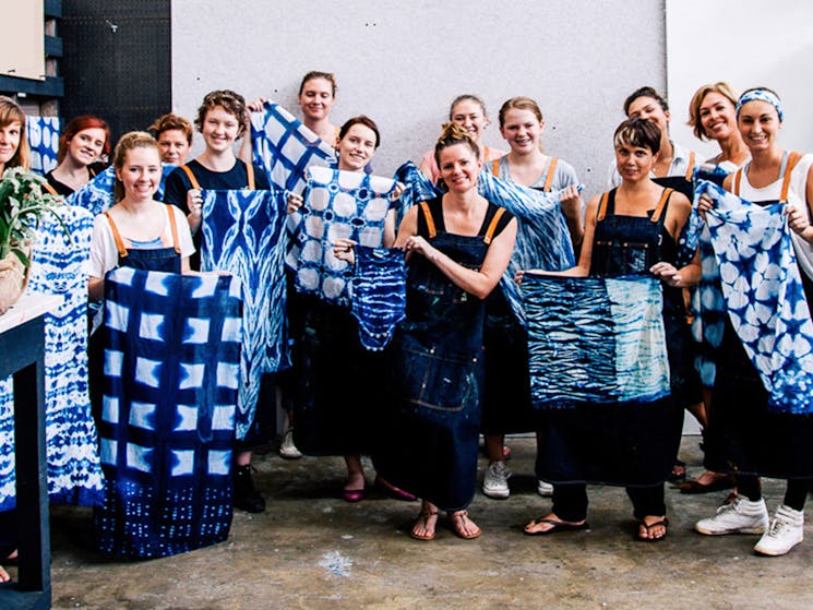 shibori classes with indigo, class members holding their work