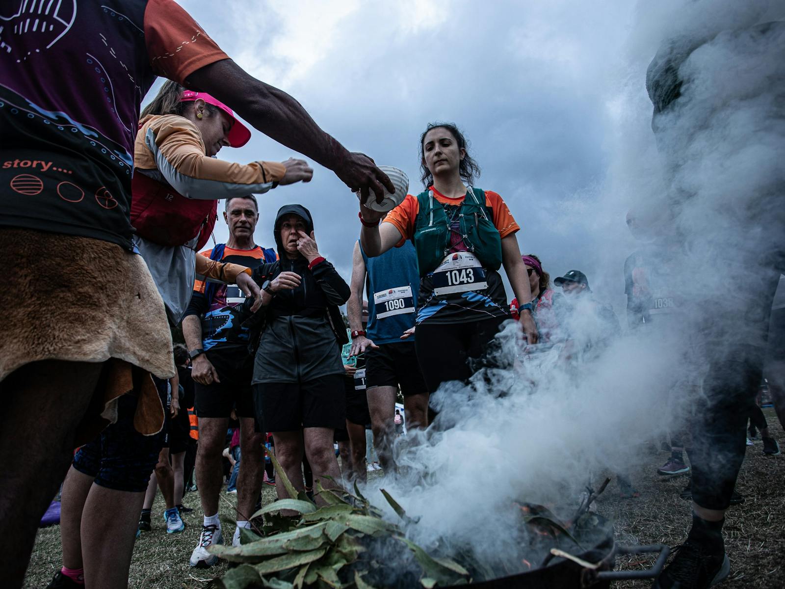 Runners participate in a smoking ceremony
