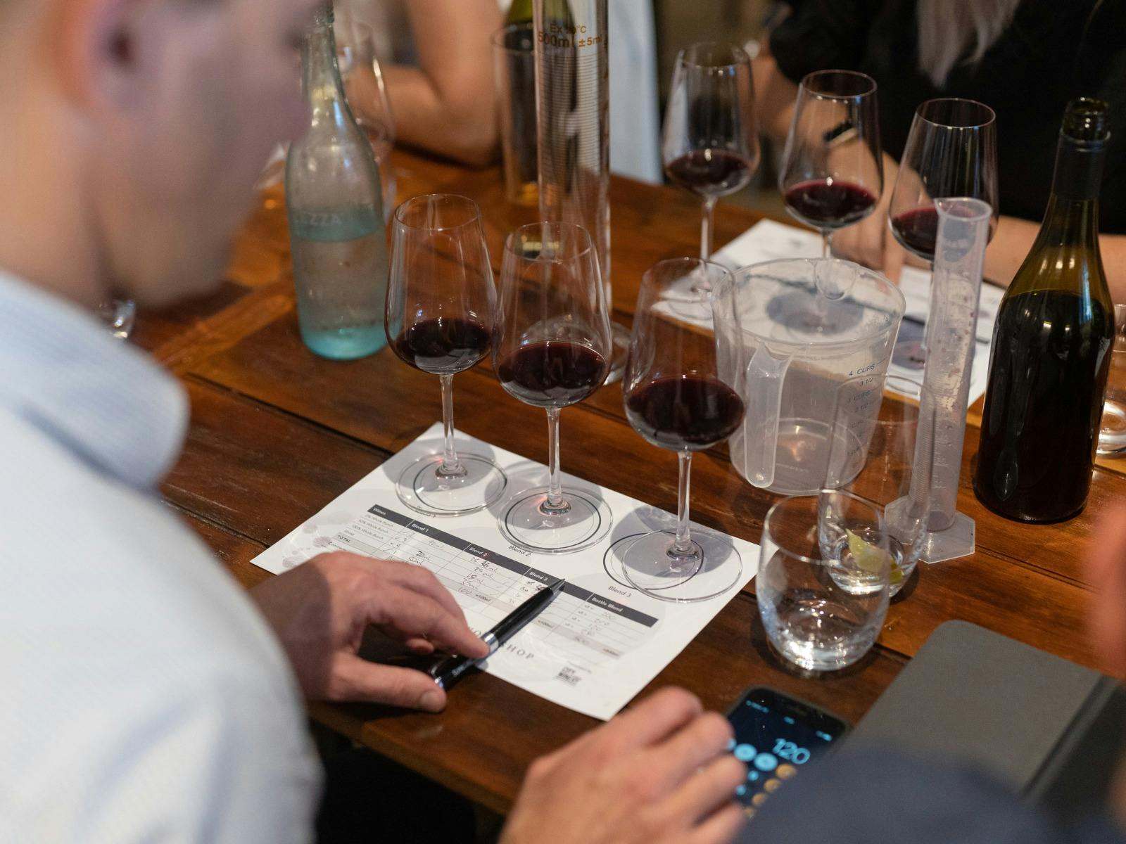 Person completing wine blending workshop worksheet