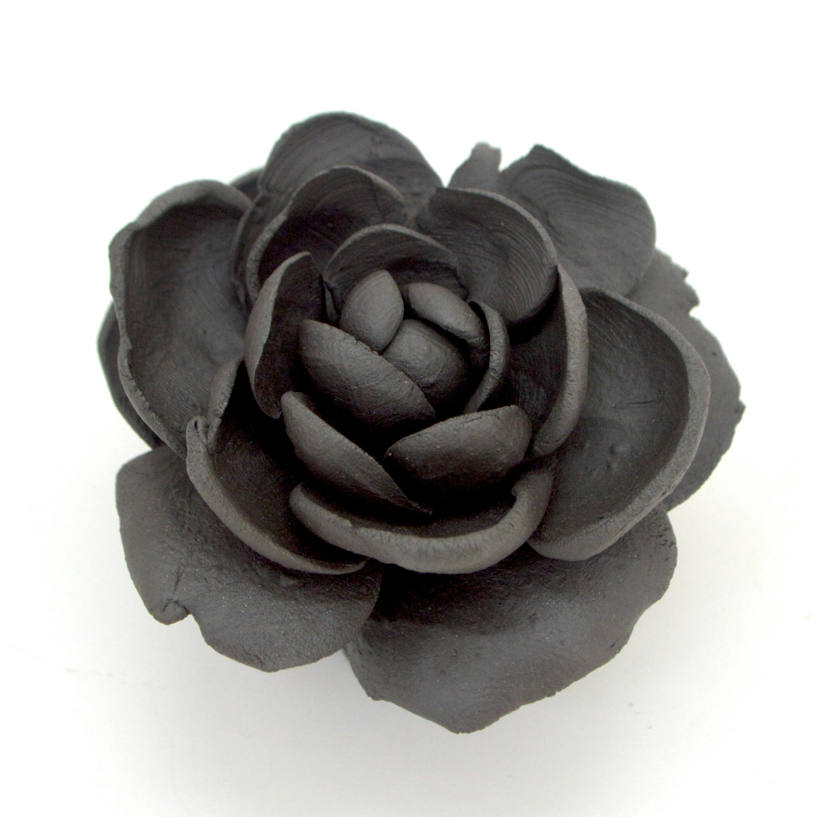 a black ceramic flower