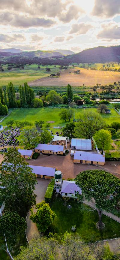Drone image of Lanyon Homestead with buildings in foreground and brindabellas in background