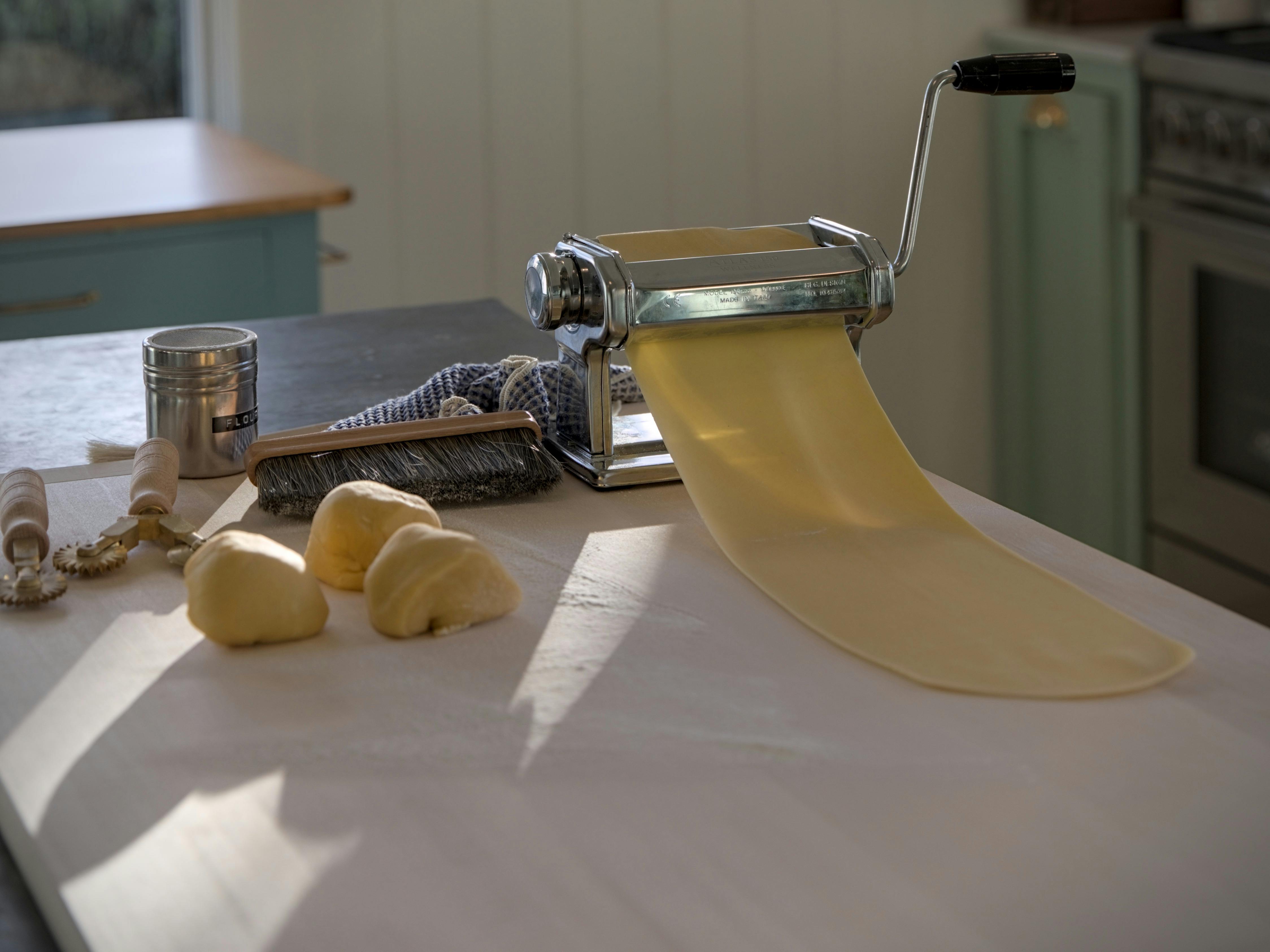 Fresh pasta dough rolled through a pasta machine at Florian Cottage cooking class.