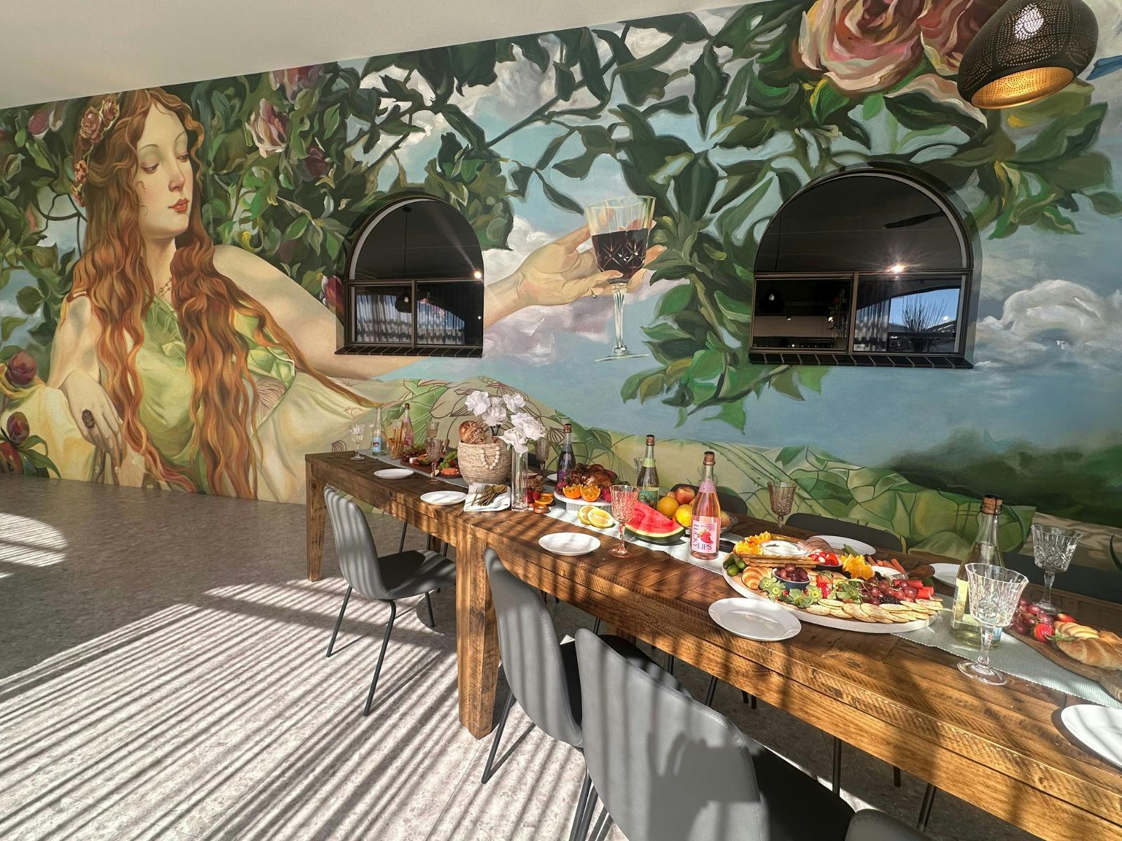 Meditrina Cellar Door & Cafe, showing a long lunch table with food and bottles of sparkling wine.