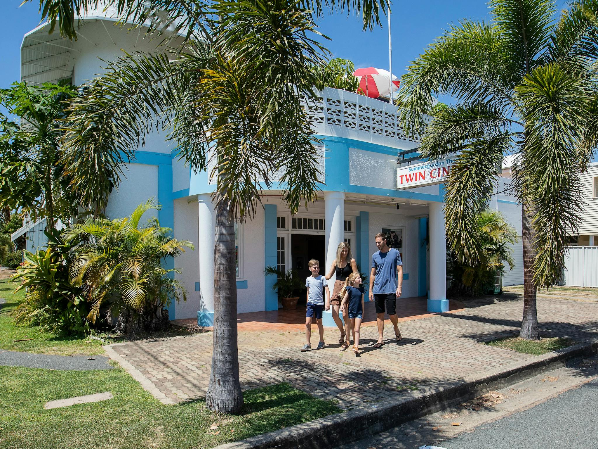 family walking in front of the Bowen Summergarden Cinema family walking in front of the Bowen Summergarden Cinema