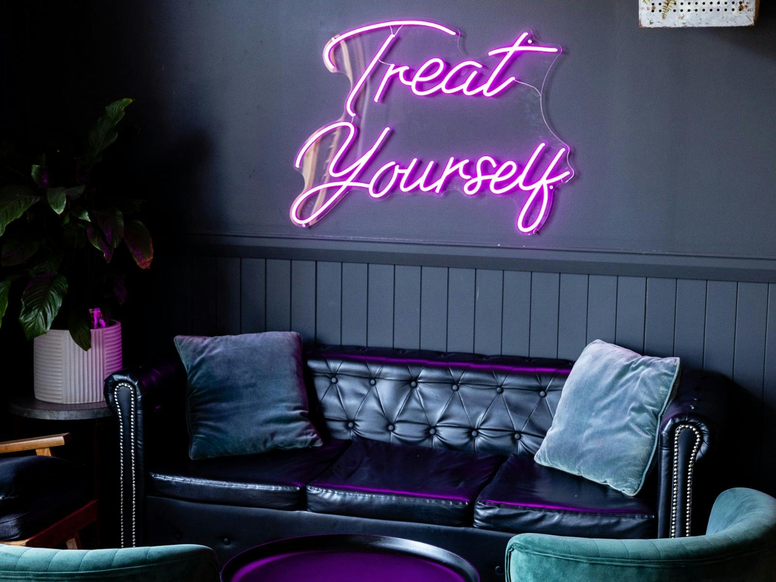 The Rutledge Bar & Eats lounge and neon sign "treat yourself"