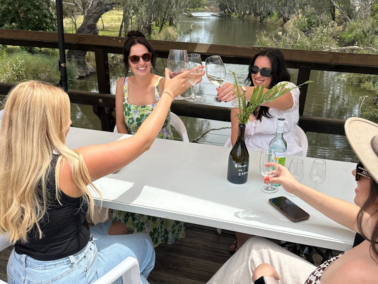 4 girls cheers wine glasses