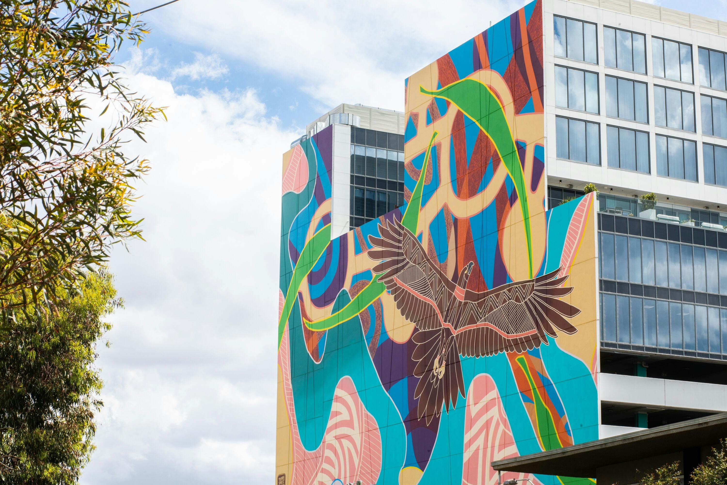 wall mural on tall building featuring a giant eagle