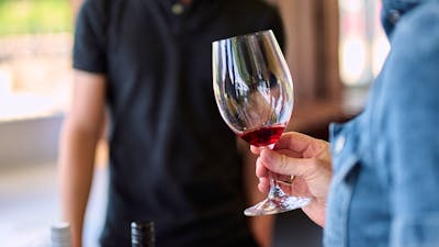 A glass of red wine is swirled