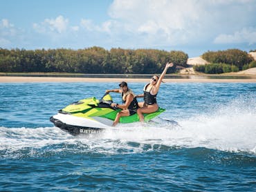 Man and woman enjoying a fun adventure on a jet ski Man and woman enjoying a fun adventure on a jet ski