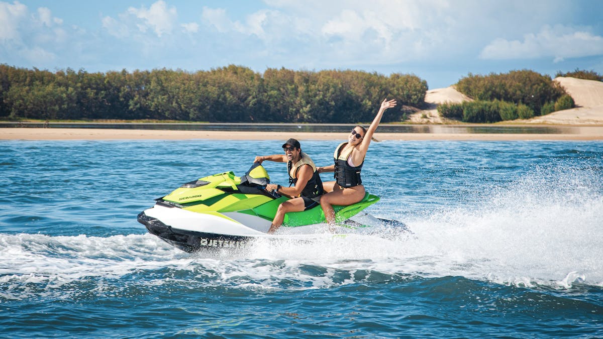 Man and woman enjoying a fun adventure on a jet ski
