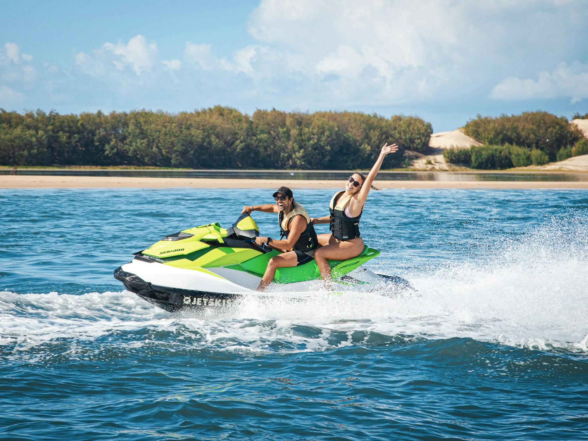Man and woman enjoying a fun adventure on a jet ski Man and woman enjoying a fun adventure on a jet ski