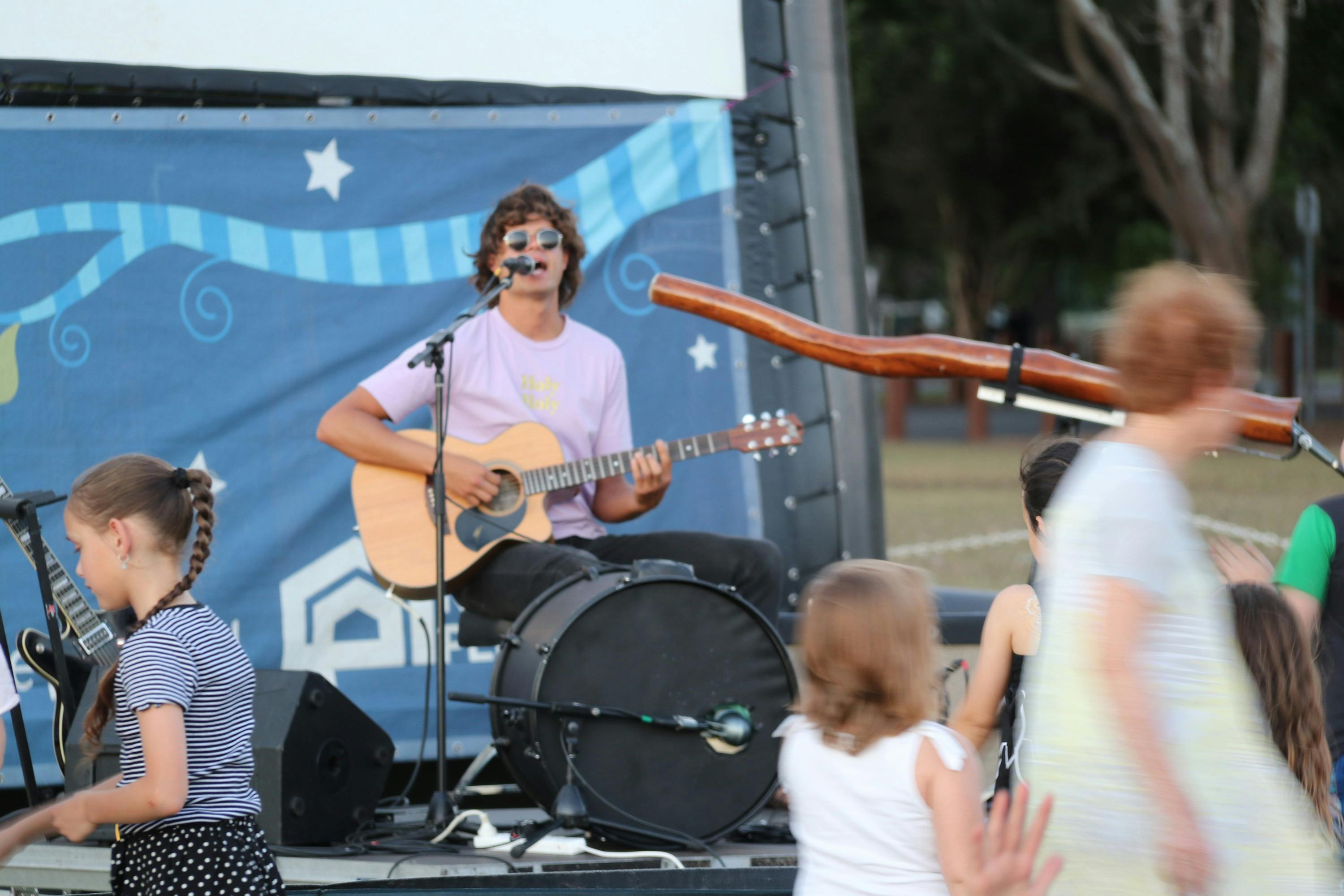 Musician performing on stage with guitar